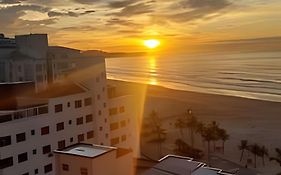 Em frente ao quiosque Ocian na praia, pé na areia